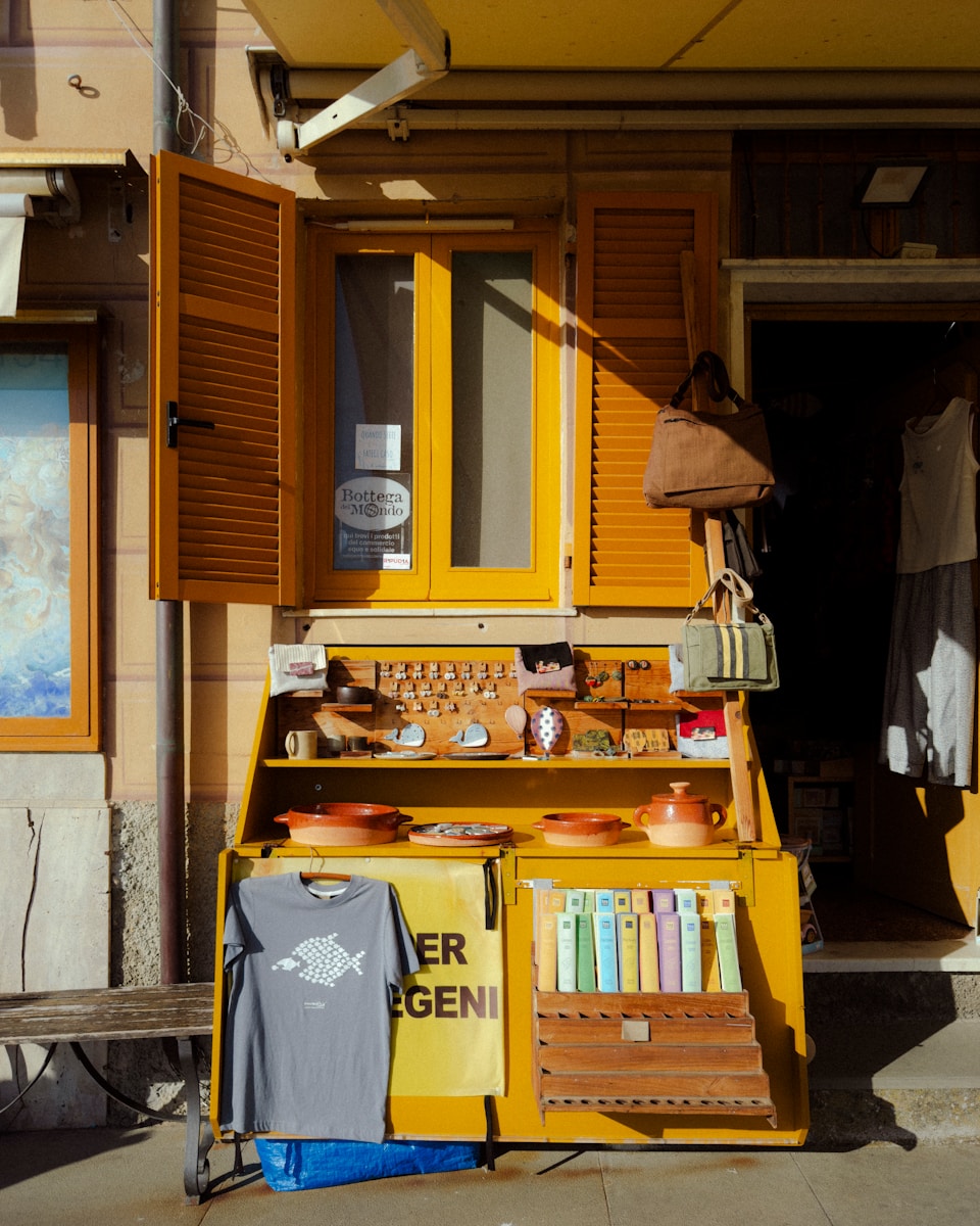 A yellow shopfront displays various goods.